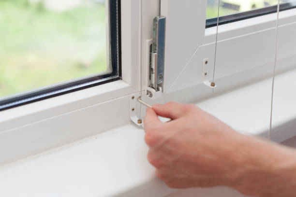 istock Handyman repairs plastic window with a hexagon. Workman adjusts the operation of the plastic window 859436160