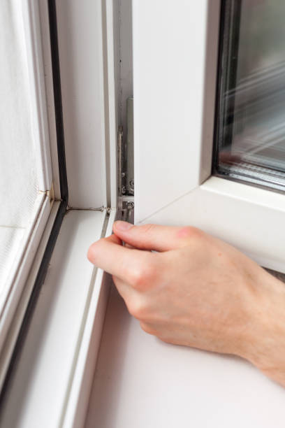 istock Handyman repairs plastic window with a hexagon. Workman adjusts the operation of the plastic window 859438276