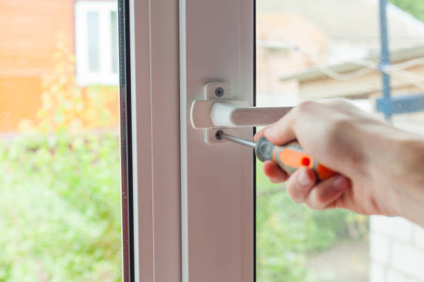 istock Handyman repairs plastic window with screwdriver. Workman adjusts the operation of the plastic window. 859438330