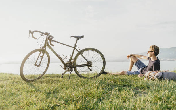 istock Cyclist rests on summer meadow. 859438610