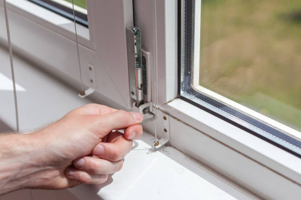 istock Handyman repairs plastic window with a hexagon. Workman adjusts the operation of the plastic window 859438614