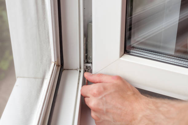 istock Handyman repairs plastic window with a hexagon. Workman adjusts the operation of the plastic window 859438630
