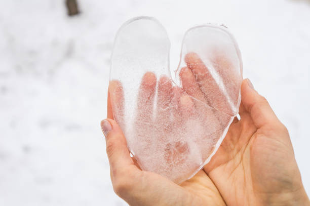 Ice heart in woman hands