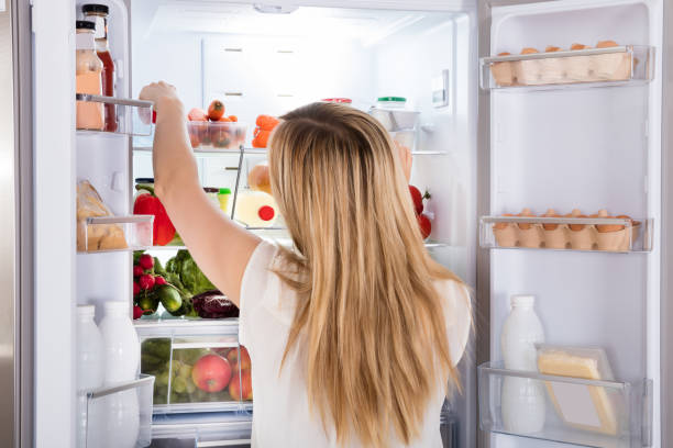 istock Woman Looking At Food In Refrigerator 859444330