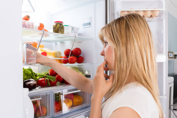 istock Young Woman Looking In Fridge 859444672