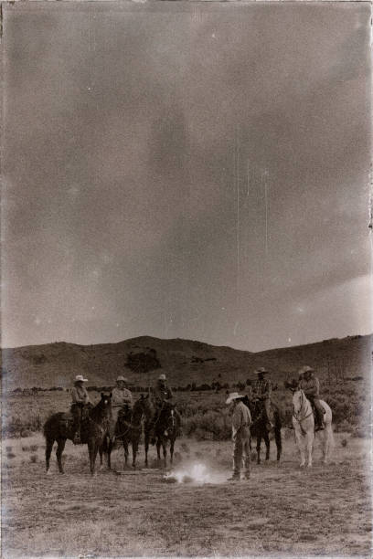 Cowboys Campfire Cowboys and Cowgirls outdoors around the campfire in the west. vintage cowgirl stock pictures, royalty-free photos & images