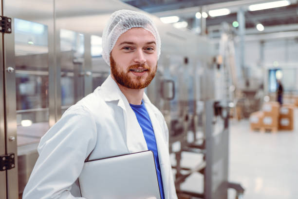 istock Young Smiling Scientist With Digital Tablet Posing in Factory 859455458