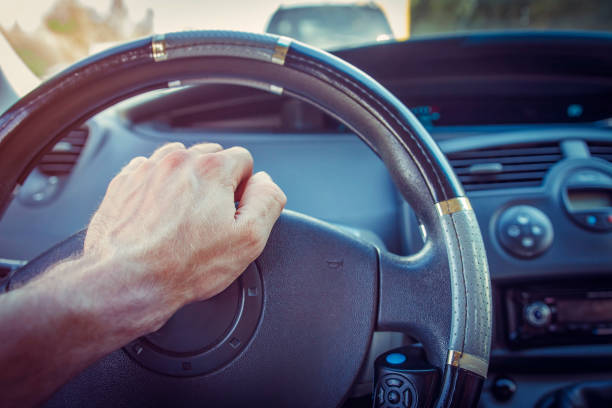 istock Driver in the car presses tone button on steering wheel. 859455666