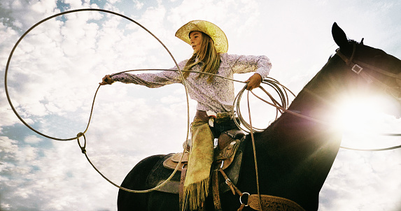 Cheerful cowgirl holding lassohttp://www.twodozendesign.info/i/1.png