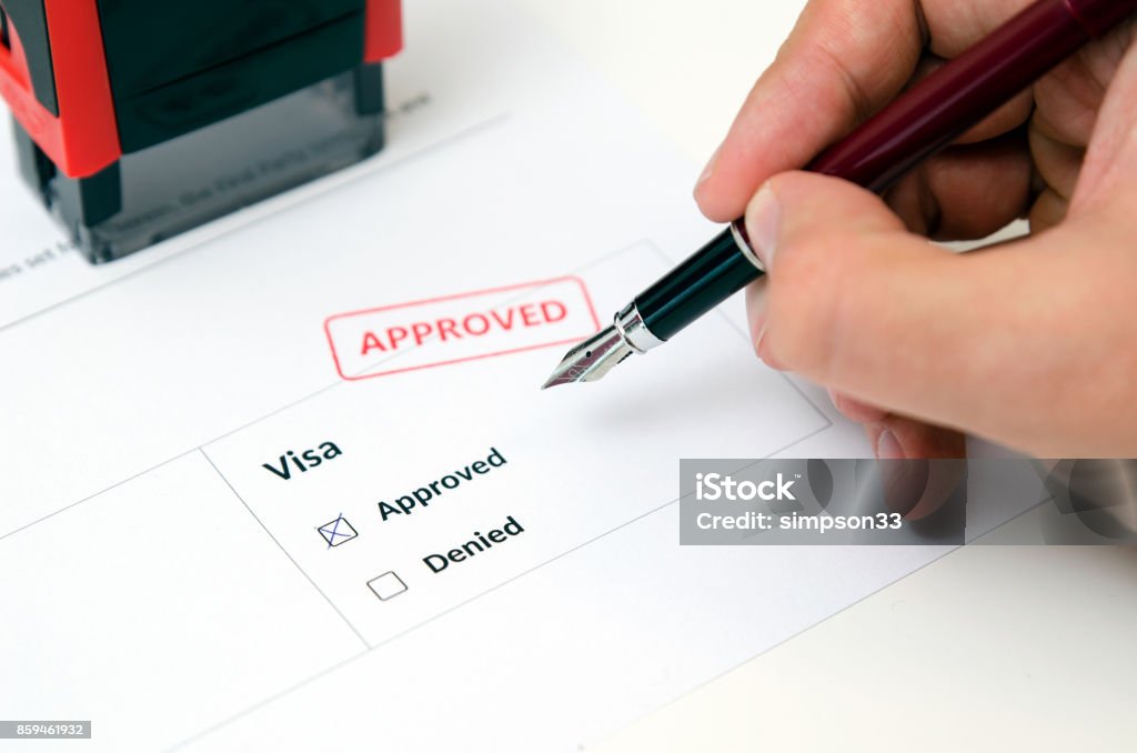 Visa and approved stamp on a document form Visa and approved stamp on a document form. Immigration and travel concept Passport Stamp Stock Photo