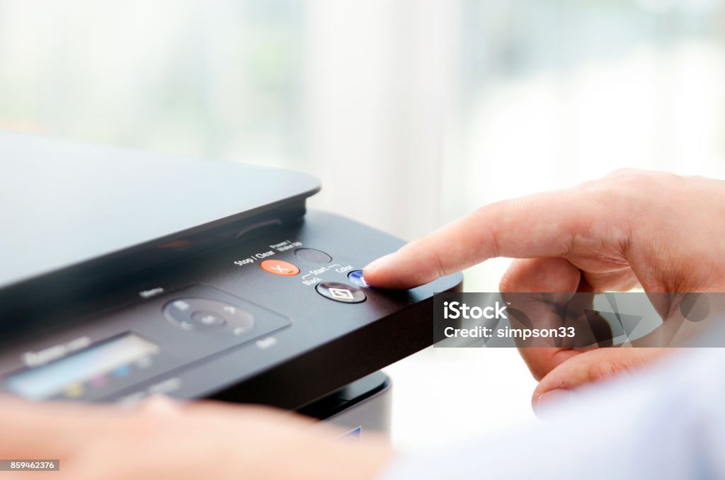 Hand press button on panel of printer Hand press button on panel of printer. printer scanner laser office copy machine supplies start concept Printer - Occupation Stock Photo