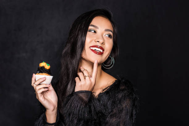 istock woman holding cupcake 859472416