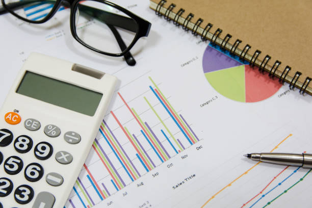 istock Office Concepts : data analyzing with calculator,glasses,notebook and pen. on charts and graph to find out the result. 859475726