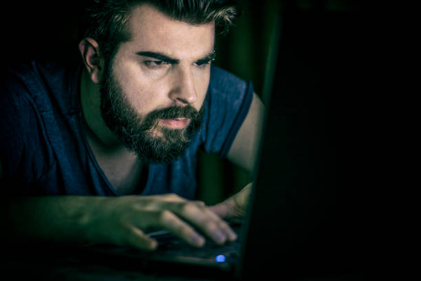 istock Handsome man working late on laptop 859481874