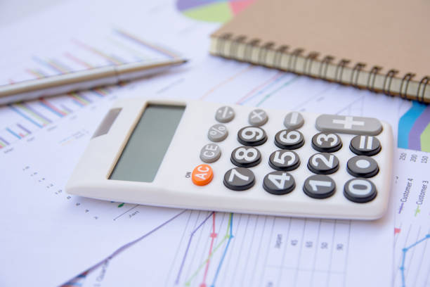istock Office Concepts : data analyzing with calculator,notebook and pen. on charts and graph to find out the result. 859485446
