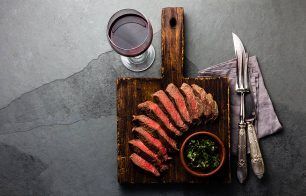 istock Medium rare beef steak with wine on slate background 859485872