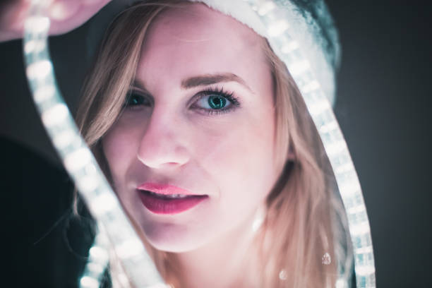 istock Young woman with christmas decorations wearing santa's hat 859489210