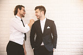 Two young smart businessmen talking together during leisure time at indoor. Business teamwork and coworker concept, Relax concept. Soft tone pinterest and instragram like process.