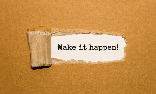 istock The text Make it happen appearing behind torn brown paper 859494552