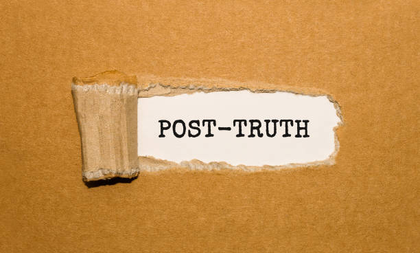 istock The text POST-TRUTH appearing behind torn brown paper 859494646