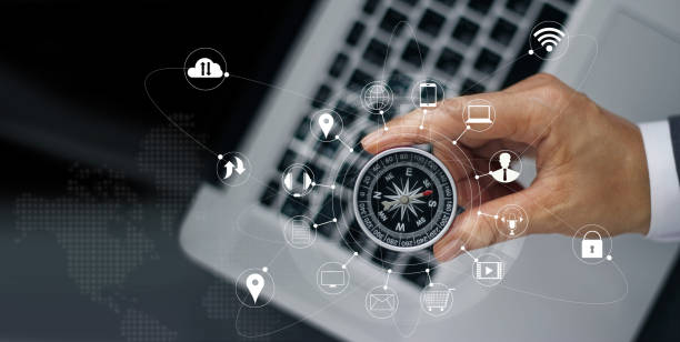 Businessman with a compass holding in hand on laptop and icon customer network connection on screen, m-banking and omni channel