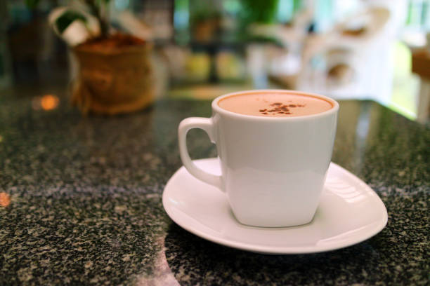 Hot cocoa hocolate in cup with cafe interior blur background