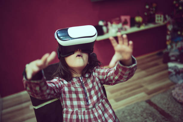 istock Little Girl Having Fun with Virtual Reality Simulator and Gesturing 859507326