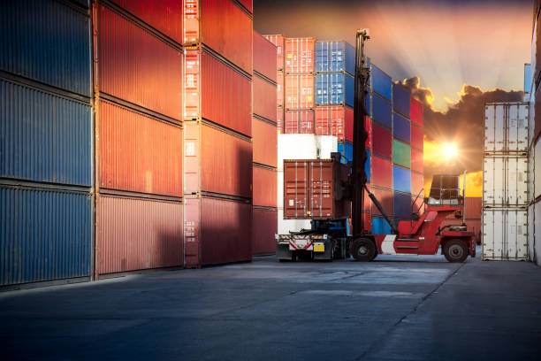 istock forklift handling container box loading to truck in import export logistic, Business logistics concept 859514328