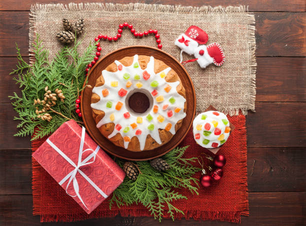 traditional decorated christmas cake at wooden table