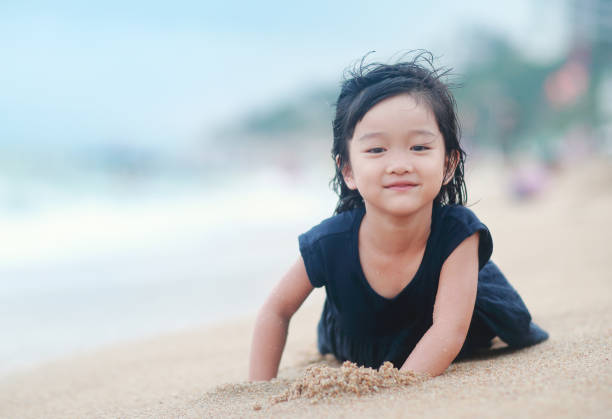 istock Children playing on the beach 859514460