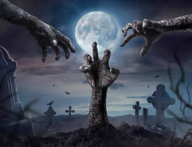 Photo of Zombie hands rising in dark Halloween night.