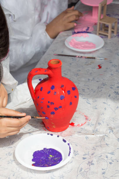 istock Young children decorating handmade clay pottery 859532256