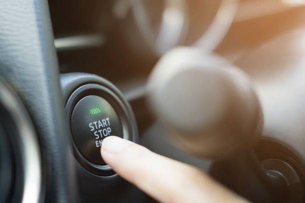istock Close up of finger pressing the start/stop engine button on car. 859540284