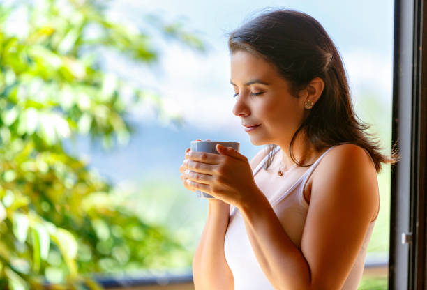 istock Hispanic cute young woman ready to drink cup of coffe 859547122