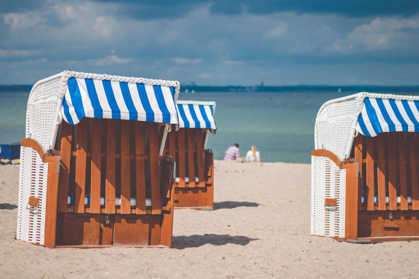 istock Colourful beach roofed chairs in Travemunde, Germany 859547798