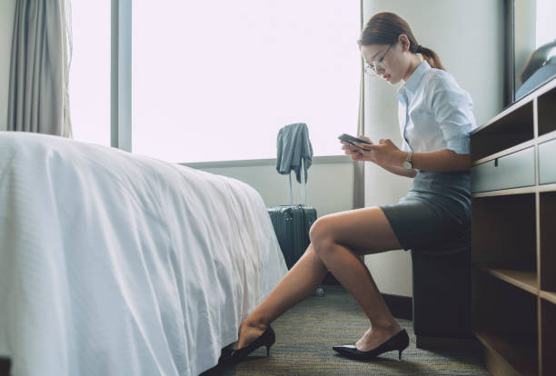istock woman sitting in room using smartphone 859550786