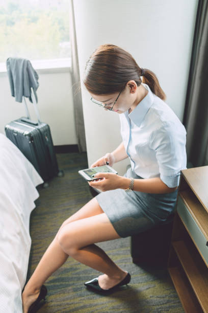 istock woman sitting in room using smartphone 859550942