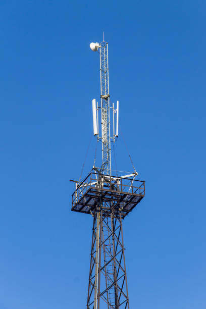 istock Metal tower with antennas for mobile cell phone communications against blue sky 859551406