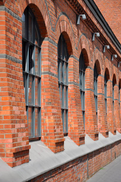 istock Old building made of red bricks. With arch windows. Side view 859553754