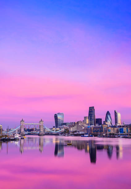 City of London Downtown Skyline and River Thames with Glowing Sunset, United Kingdom Tower Bridge and the Still Waters of the River Thames With Refection of Warm Coloured Sunset Clouds thames river stock pictures, royalty-free photos & images