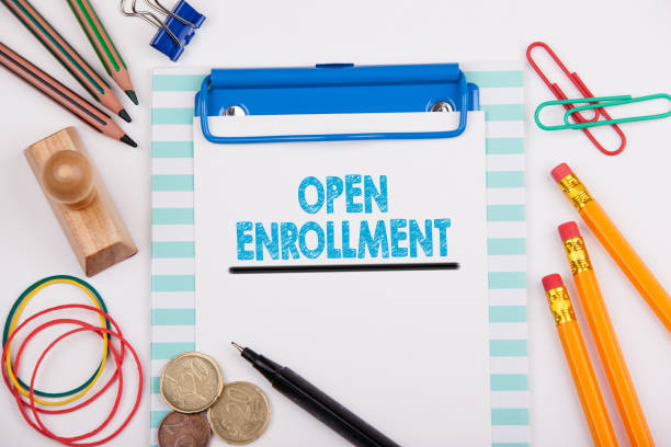 istock Open Enrollment. White office desk with stationery 859561928
