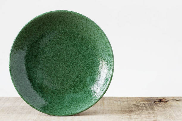 istock Green plate on wooden. 859564900
