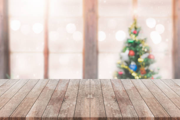 istock Wood table top on blur with bokeh christmas tree background with snowfall - can be used for display or montage your products. 859571590