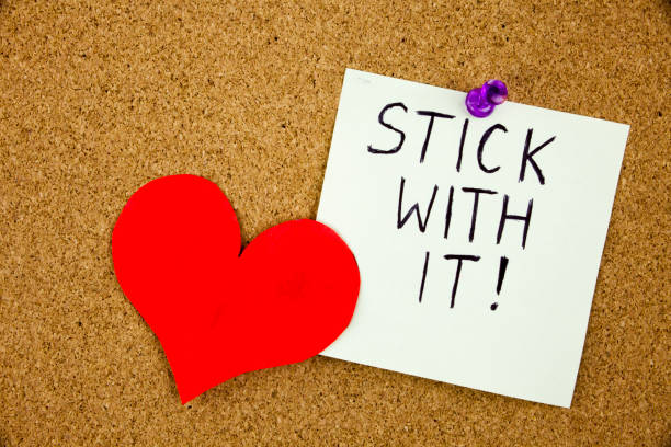 istock A sticky note Stick with it tacked to cork board 859571946
