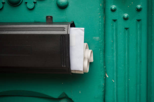 Mailbox with newspaper and mail at a door