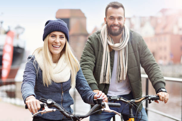 istock Young couple riding bikes and having fun in the city 859575264