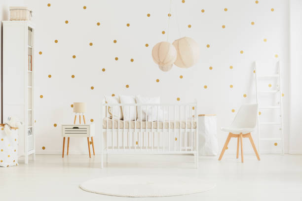 pastell laternen über dem bett des babys - bedroom stage stock-fotos und bilder