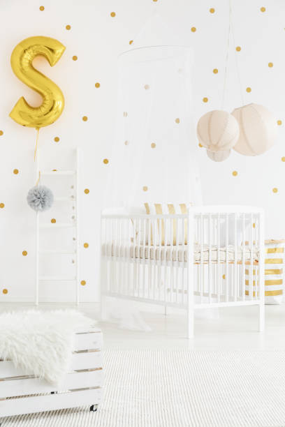 istock Baby's bedroom with gold balloon 859575586