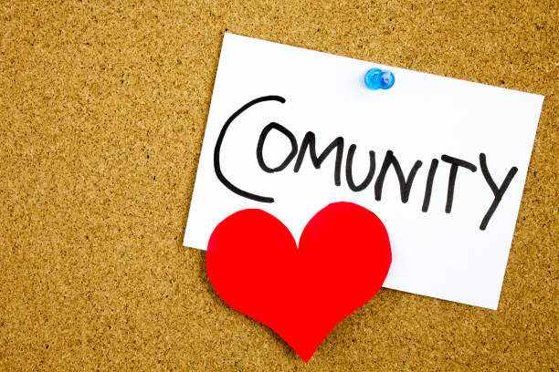 istock Community word with red heart on a sticky note against a cork notice 859575672