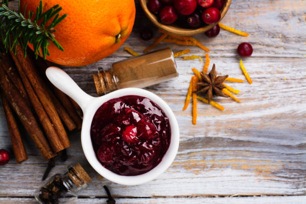 istock Cranberry sauce with ingredients on wooden table 859576036